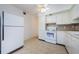 Kitchen featuring white appliances, ample cabinetry, and a functional layout at 4154 57Th N St # 173, Kenneth City, FL 33709