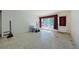 Bare living room with terrazzo floors and window with red drapes at 4154 57Th N St # 173, Kenneth City, FL 33709