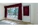 Bright living room featuring a large window with red curtains at 4154 57Th N St # 173, Kenneth City, FL 33709