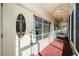 Covered red concrete patio with decorative front door with window at 4154 57Th N St # 173, Kenneth City, FL 33709