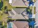 Aerial view of a home with a new roof, maintained lawn, and a pool in the backyard at 4506 Mapletree Loop, Wesley Chapel, FL 33544