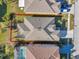 Aerial view of backyard, property lines, nearby homes, and screened in pool at 4506 Mapletree Loop, Wesley Chapel, FL 33544
