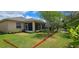 This backyard features lush landscaping and a full, green lawn at 4506 Mapletree Loop, Wesley Chapel, FL 33544