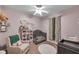 Bedroom with soft pink walls, a crib, changing table, and comfortable recliner at 4506 Mapletree Loop, Wesley Chapel, FL 33544
