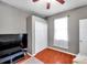 This bedroom offers hardwood floors, a modern ceiling fan, and a closet at 4506 Mapletree Loop, Wesley Chapel, FL 33544