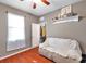 This bedroom offers hardwood floors, natural light, and an over-the-door storage at 4506 Mapletree Loop, Wesley Chapel, FL 33544