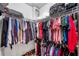 Walk-in closet fully stocked with a variety of clothing items and shoe racks at 4506 Mapletree Loop, Wesley Chapel, FL 33544