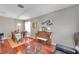 Dining room featuring wood floors, an ornate chandelier and a vintage piano in a staged setting at 4506 Mapletree Loop, Wesley Chapel, FL 33544