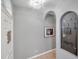 Inviting foyer with neutral tones, unique wall decor, and arched doorways at 4506 Mapletree Loop, Wesley Chapel, FL 33544