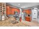Well-equipped kitchen featuring granite countertops, stainless steel appliances, and wooden cabinets at 4506 Mapletree Loop, Wesley Chapel, FL 33544