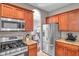 This kitchen offers stainless steel appliances, granite countertops, and a pass-through to the dining room at 4506 Mapletree Loop, Wesley Chapel, FL 33544