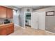 This kitchen offers custom cabinets with granite countertops, with laundry room and pantry at 4506 Mapletree Loop, Wesley Chapel, FL 33544