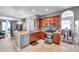 Open kitchen with stainless steel appliances, granite counters, and seamless transition to the dining area at 4506 Mapletree Loop, Wesley Chapel, FL 33544