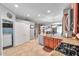 Spacious kitchen featuring granite countertops, stainless steel appliances and adjacent laundry room at 4506 Mapletree Loop, Wesley Chapel, FL 33544
