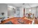 Open-concept living space with hardwood floors, arched openings, and seamless flow to dining area at 4506 Mapletree Loop, Wesley Chapel, FL 33544