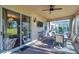 This patio features a ceiling fan, television, and views of the fenced in yard at 4506 Mapletree Loop, Wesley Chapel, FL 33544