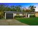 Charming one-story home with a well-manicured lawn, attached garage, and lovely landscaping at 4519 S Hesperides St, Tampa, FL 33611