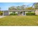 Well-maintained front yard, a charming entrance with seating, and attached garage to a single-story home at 4519 S Hesperides St, Tampa, FL 33611