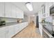 Spacious kitchen featuring stainless steel appliances, modern lighting, granite countertops, and ample cabinet space at 4519 S Hesperides St, Tampa, FL 33611