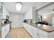 Well-appointed kitchen with granite countertops, white cabinetry, and stainless-steel appliances, blending seamlessly into the living area at 4519 S Hesperides St, Tampa, FL 33611