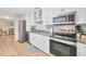 Modern kitchen featuring stainless steel appliances, granite countertops, and ample cabinet space, adjoining the dining area at 4519 S Hesperides St, Tampa, FL 33611