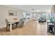 Open-concept living and dining area boasts wood floors, a dining table with four chairs, and ample natural light at 4519 S Hesperides St, Tampa, FL 33611