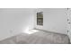 Bedroom featuring neutral carpet and black-framed window at 5237 Aberback St, North Port, FL 34291