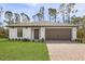 Charming one-story home showcasing a well-manicured lawn, brown two-car garage, and neutral-toned exterior at 5237 Aberback St, North Port, FL 34291