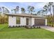 One-story home displaying a lush green lawn and a neutral-toned exterior with a brown two-car garage at 5237 Aberback St, North Port, FL 34291