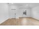 Bright living room with white walls, wood look tile flooring, and a window for natural light at 5237 Aberback St, North Port, FL 34291