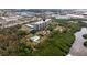 An aerial view showcases the apartment building, pool, and surrounding trees at 5400 Park N St # 209, St Petersburg, FL 33709