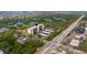 This aerial view shows the complex with tennis court surrounded by lush greenery and mangrove-lined waterways at 5400 Park N St # 209, St Petersburg, FL 33709