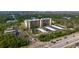 Aerial view showcases the building, parking, and tropical surrounding foliage at 5400 Park N St # 209, St Petersburg, FL 33709
