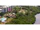 An aerial view of the condo complex with a pool, tennis court, and lush landscaping at 5400 Park N St # 209, St Petersburg, FL 33709