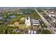 The aerial view displays the community pool, tennis court, parking, and nearby waterway at 5400 Park N St # 209, St Petersburg, FL 33709