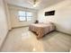 Well-lit bedroom featuring large windows, a ceiling fan, and neutral wall art at 5400 Park N St # 209, St Petersburg, FL 33709