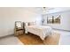 Bedroom featuring a bed with light colored linens, a fan, and a window at 5400 Park N St # 209, St Petersburg, FL 33709