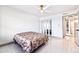 Well-lit bedroom featuring tile floors, a ceiling fan, and a mirrored closet at 5400 Park N St # 209, St Petersburg, FL 33709