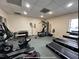 Well-lit gym features treadmills, elliptical machine, weight machine, stationary bike, and free weights for a complete workout at 5400 Park N St # 209, St Petersburg, FL 33709