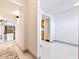 Bright hallway leading to a room with a kitchen view, showcasing the open layout of the home at 5400 Park N St # 209, St Petersburg, FL 33709