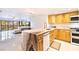 Bright kitchen with natural wood cabinets, marble countertops, and stainless steel appliances at 5400 Park N St # 209, St Petersburg, FL 33709