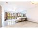Spacious living room with balcony access, tile flooring, and abundant natural light at 5400 Park N St # 209, St Petersburg, FL 33709