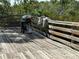 Deck area featuring an outdoor grill and wooded surroundings at 5400 Park N St # 209, St Petersburg, FL 33709