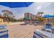 Community pool deck area with seating, shade umbrellas and complex view at 5400 Park N St # 209, St Petersburg, FL 33709