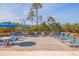 Outdoor deck area with seating, umbrellas, and serene natural views at 5400 Park N St # 209, St Petersburg, FL 33709