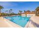 Community pool with clear blue water, seating, and surrounding trees at 5400 Park N St # 209, St Petersburg, FL 33709