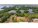 Aerial shot of tennis courts surrounded by greenery and waterways on a sunny day at 5400 Park N St # 209, St Petersburg, FL 33709