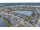Aerial view of houses surrounding a lake in a residential neighborhood at 6216 Kevesta Ave, Palmetto, FL 34221