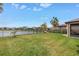 Expansive backyard with green grass and fenced waterside views, perfect for outdoor enjoyment and relaxation at 6216 Kevesta Ave, Palmetto, FL 34221
