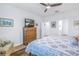 Bright bedroom with ceiling fan, hard wood floors, television, and ensuite bathroom at 6216 Kevesta Ave, Palmetto, FL 34221